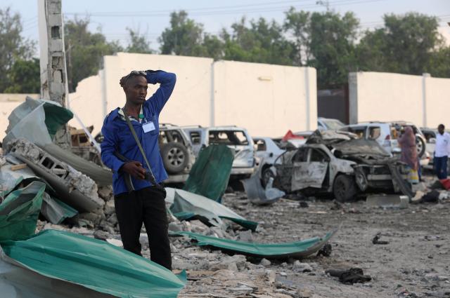 A security officer from Doorbin Hotel assesses the debris after a suicide car explosion in front of the hotel in Mogadishu